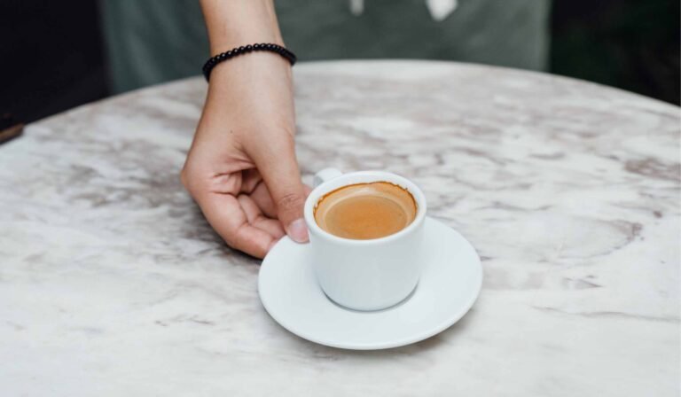 Hand Serving an Espresso