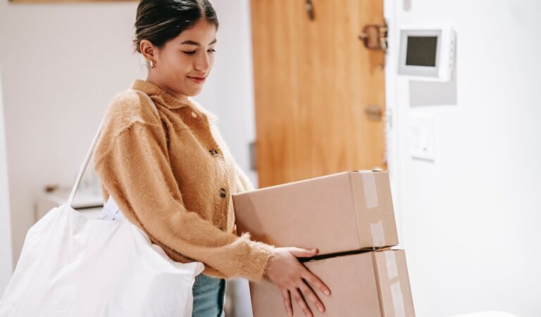 Woman holding Amazon boxes
